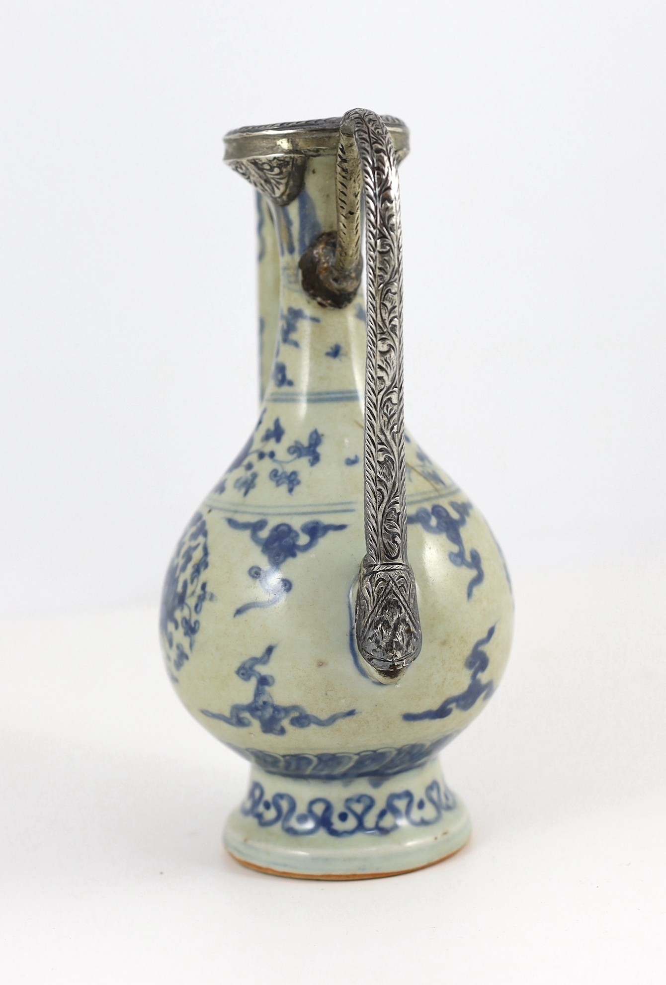 A Chinese late Ming blue and white ewer, made for the Islamic market, Jiajing to Wanli period, 21cm high, damage and later Islamic silver mounts